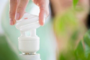 Hand installing LED light bulb
